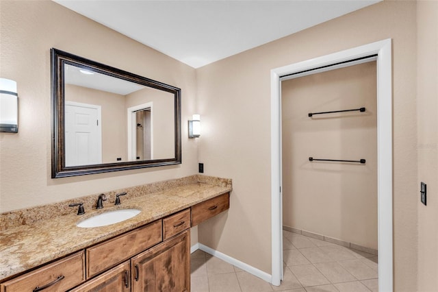 bathroom featuring vanity, baseboards, and tile patterned floors