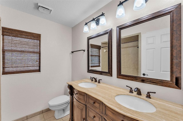 bathroom featuring tile patterned flooring, a sink, double vanity, and toilet