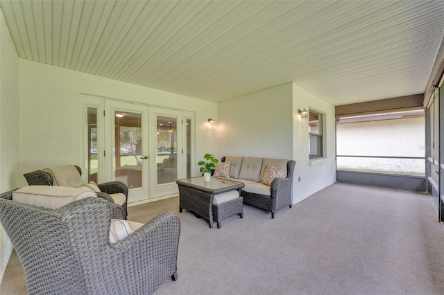 carpeted living area with french doors