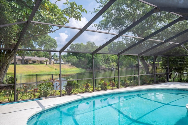 view of swimming pool with a water view and a lanai
