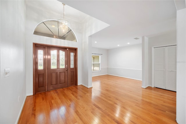 foyer entrance with light wood-style floors, a chandelier, baseboards, and recessed lighting