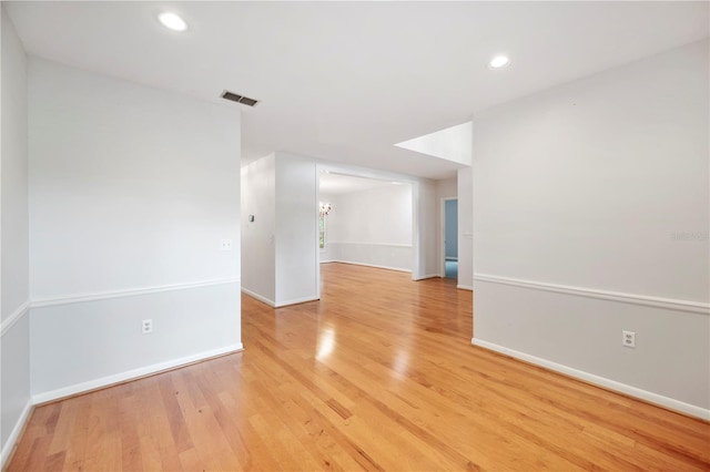 unfurnished room featuring light wood-style floors, baseboards, and recessed lighting