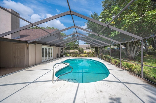 swimming pool featuring french doors, a patio, and glass enclosure