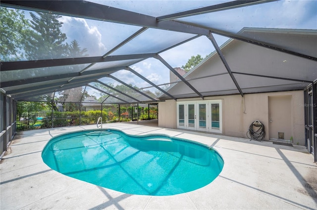 outdoor pool featuring french doors and a patio