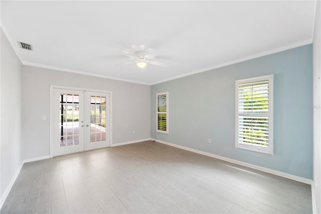 spare room featuring ceiling fan, ornamental molding, baseboards, and french doors