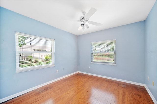 unfurnished room with baseboards, wood finished floors, and ceiling fan