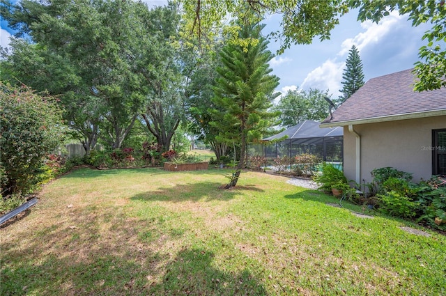 view of green lawn featuring a lanai