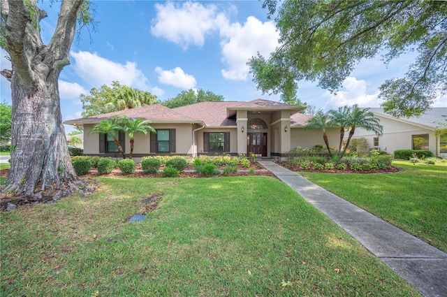 view of front of property with stucco siding and a front yard