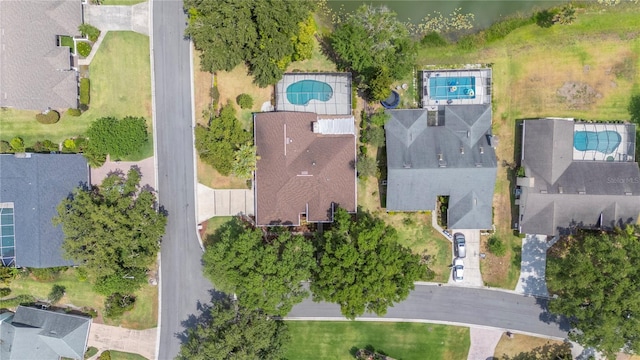 aerial view of property and surrounding area with a pool area and nearby suburban area