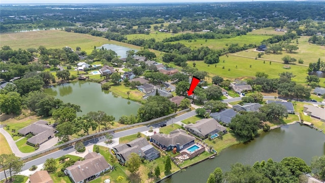 aerial overview of property's location with a large body of water and nearby suburban area
