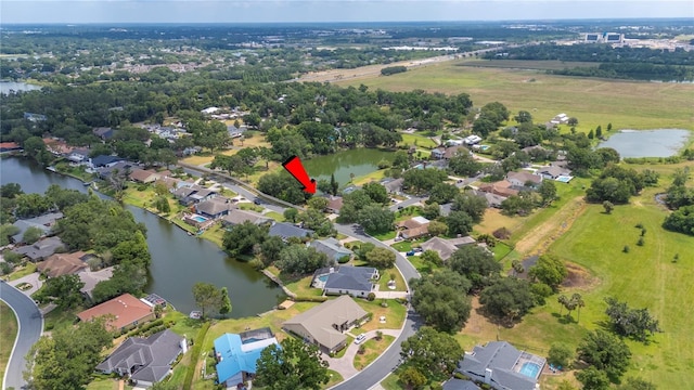 view of property location with a nearby body of water and nearby suburban area