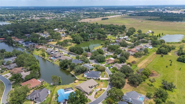 aerial view of property's location with a nearby body of water and nearby suburban area