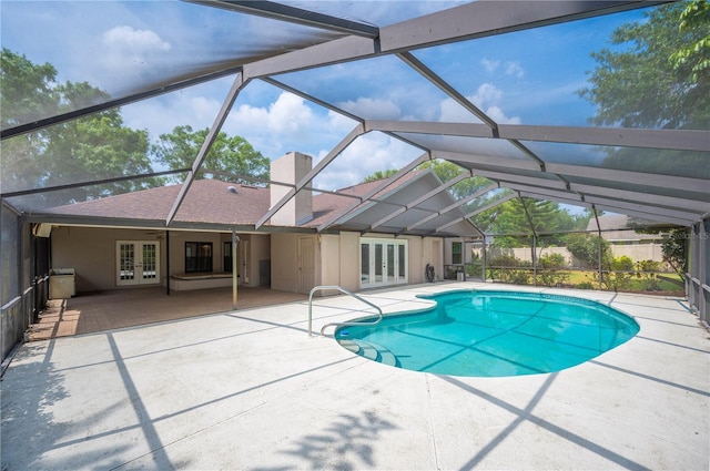 view of swimming pool featuring french doors, a patio, and glass enclosure
