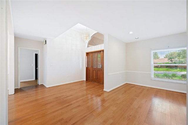 1104 Kells Ct, Lakeland, FL 33813 - spare room with a chandelier, light wood finished floors, and baseboards