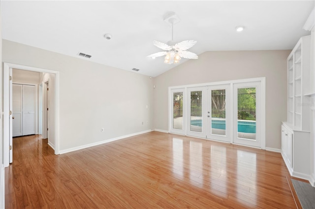 1104 Kells Ct, Lakeland, FL 33813 - empty room featuring lofted ceiling, french doors, light wood-style flooring, and baseboards