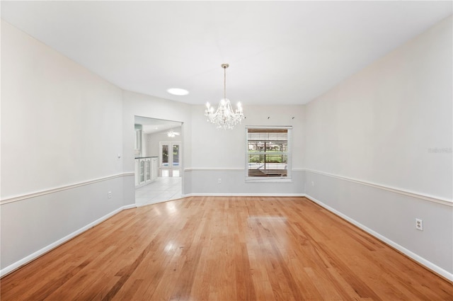 1104 Kells Ct, Lakeland, FL 33813 - unfurnished dining area featuring a chandelier, light wood-style floors, and baseboards