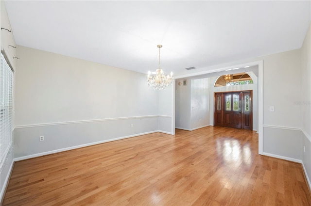 1104 Kells Ct, Lakeland, FL 33813 - spare room with a chandelier, light wood-type flooring, and baseboards
