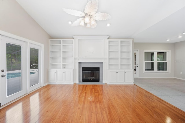 1104 Kells Ct, Lakeland, FL 33813 - unfurnished living room featuring a fireplace with flush hearth, vaulted ceiling, recessed lighting, light wood-type flooring, and a ceiling fan