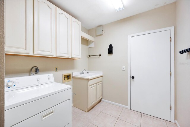 1104 Kells Ct, Lakeland, FL 33813 - laundry room with washer / clothes dryer, cabinet space, light tile patterned floors, and baseboards