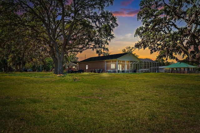 view of yard at dusk