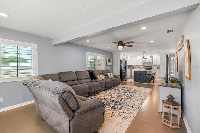 living room featuring visible vents, recessed lighting, light wood-style floors, and ceiling fan