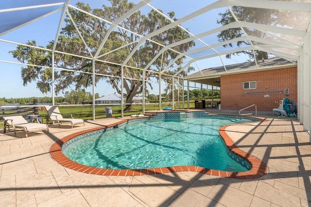 outdoor pool featuring glass enclosure, a patio, and a jacuzzi