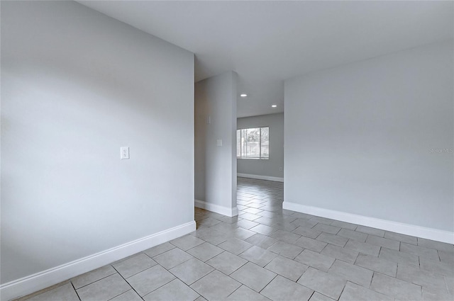 unfurnished room with baseboards, recessed lighting, and light tile patterned flooring