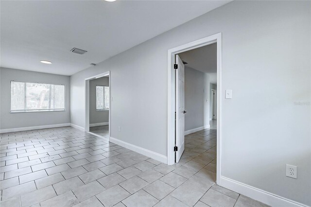 unfurnished room featuring recessed lighting, visible vents, baseboards, and light tile patterned floors