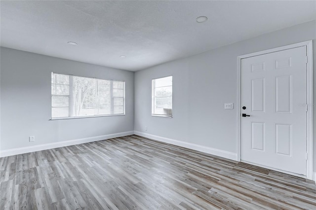 interior space featuring baseboards and wood finished floors