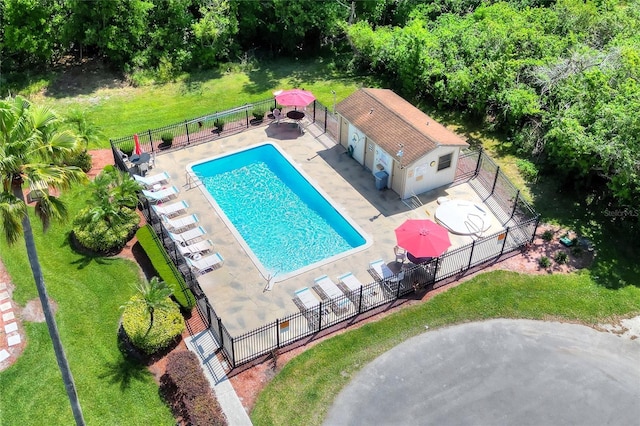 community pool featuring fence, a yard, and a patio