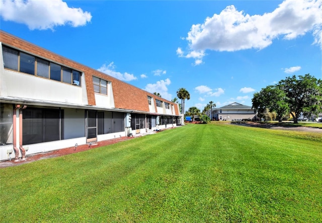 view of yard with a sunroom