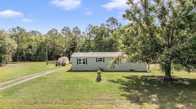 view of front of property with driveway and a front lawn