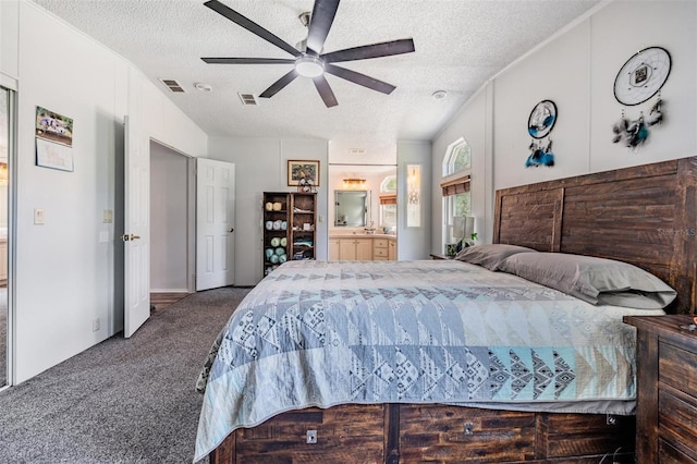 carpeted bedroom featuring connected bathroom, a textured ceiling, and visible vents