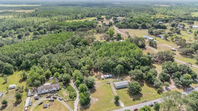 birds eye view of property featuring a view of trees