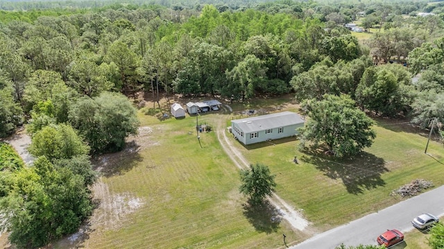 birds eye view of property with a wooded view