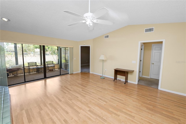 unfurnished living room featuring light wood-style floors, lofted ceiling, visible vents, and ceiling fan
