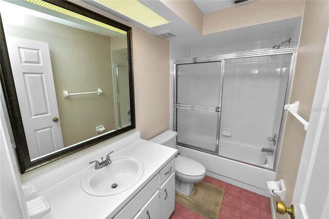 full bathroom featuring tile patterned floors, toilet, visible vents, combined bath / shower with glass door, and vanity