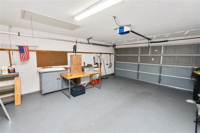 garage with a workshop area and a garage door opener