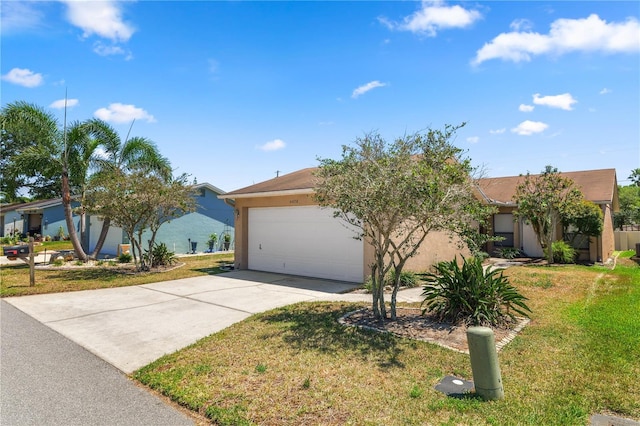 view of front of property featuring stucco siding, an attached garage, driveway, and a front lawn