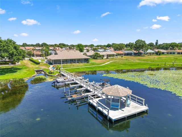 view of dock featuring a residential view, a water view, and boat lift