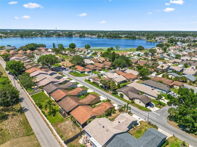 drone / aerial view featuring a residential view and a water view