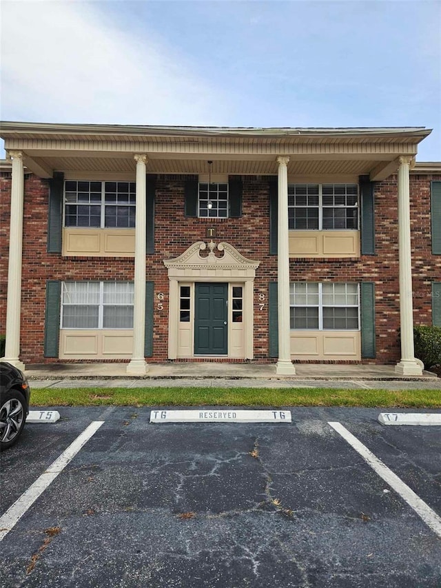 view of building exterior with uncovered parking