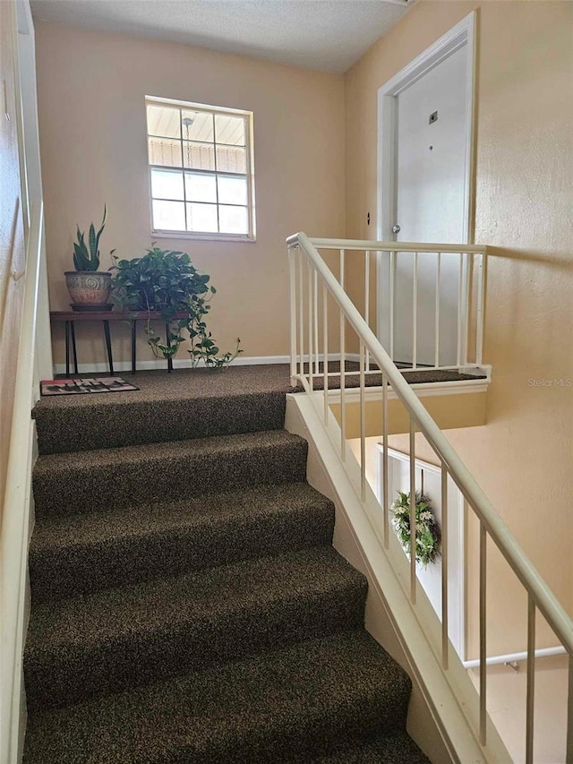stairs featuring baseboards