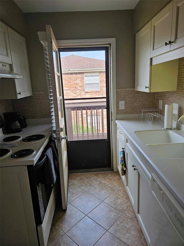 kitchen featuring dishwasher, electric range, a sink, white cabinets, and decorative backsplash