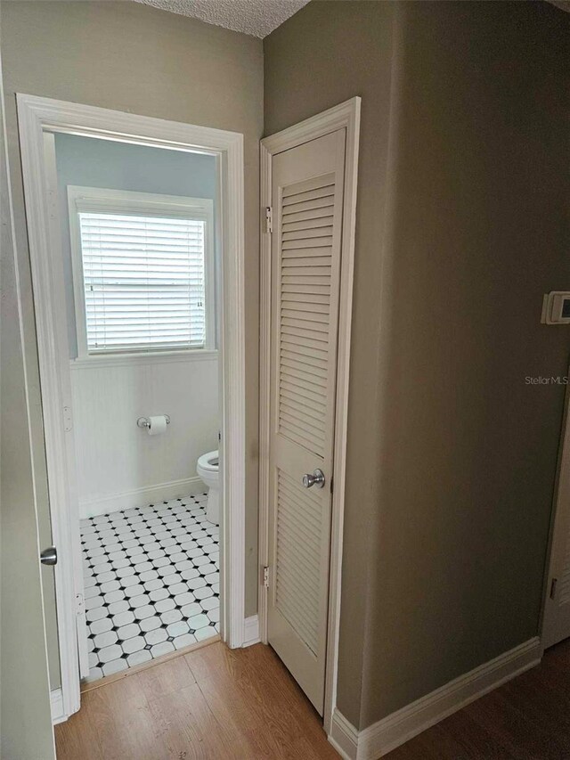bathroom featuring toilet and baseboards