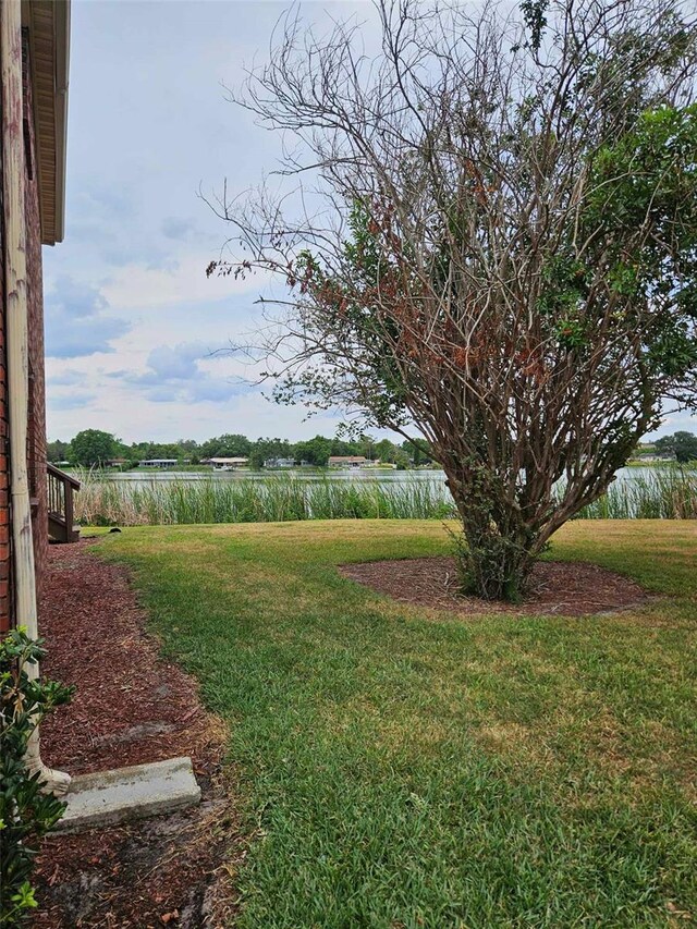 view of grassy yard with a water view