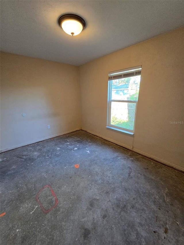 911 White Ln NE, Steinhatchee, FL 32359 - unfurnished room with unfinished concrete flooring and baseboards