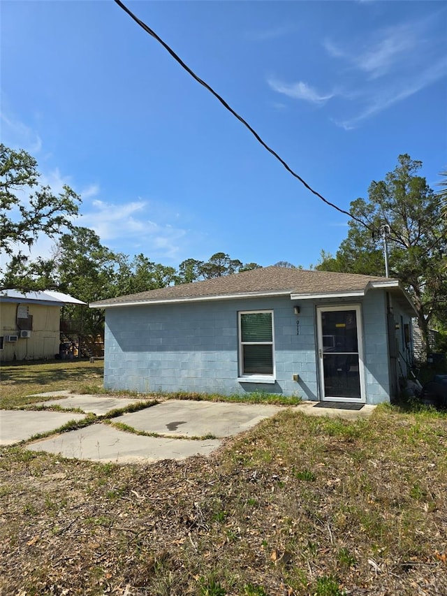 911 White Ln NE, Steinhatchee, FL 32359 - back of house with concrete block siding and roof with shingles