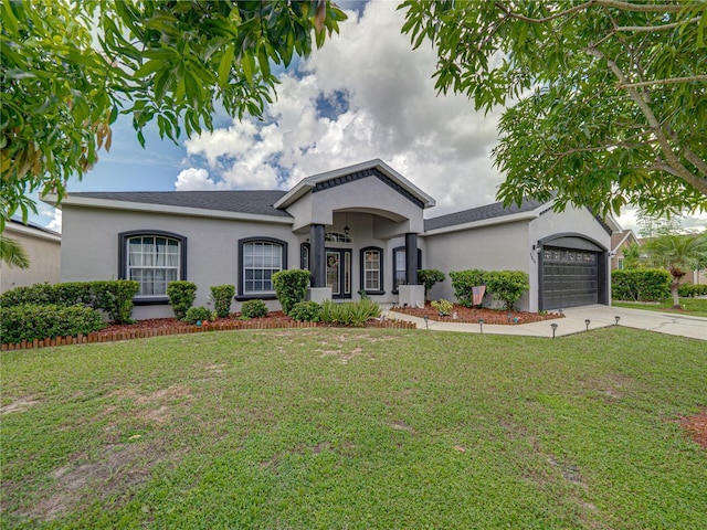 2033 Normandy Heights Dr, Winter Haven, FL 33880 - ranch-style house with stucco siding, concrete driveway, a garage, and a front lawn