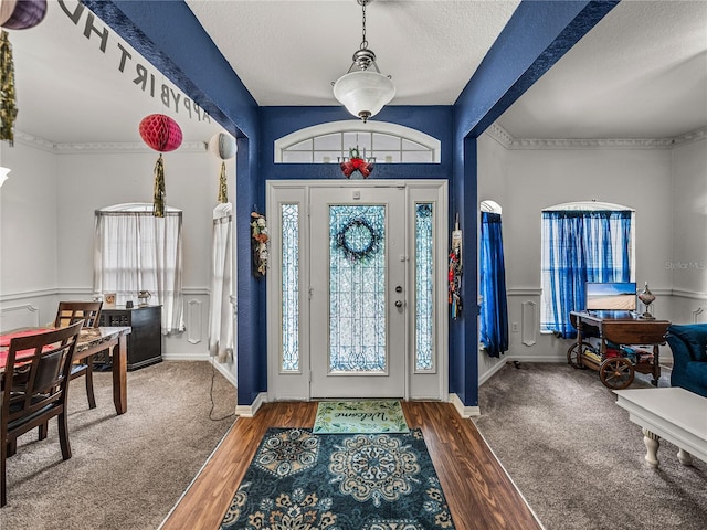 2033 Normandy Heights Dr, Winter Haven, FL 33880 - foyer entrance with healthy amount of natural light, wood finished floors, and a textured ceiling